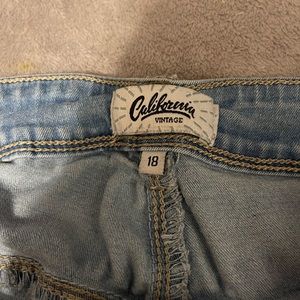 size 18 jeans, light blue with rips in them.